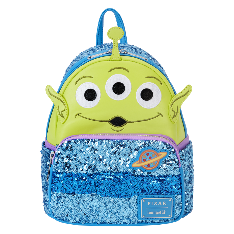 Loungefly Exclusive Toy Story Alien Sequin Mini Backpack, featuring a green three-eyed alien on the front wearing a blue space suit made of light blue sequins. Bag sits against a white background